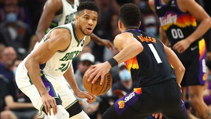 Milwaukee Bucks forward Giannis Antetokounmpo (34) defends against Phoenix Suns guard Devin Booker.